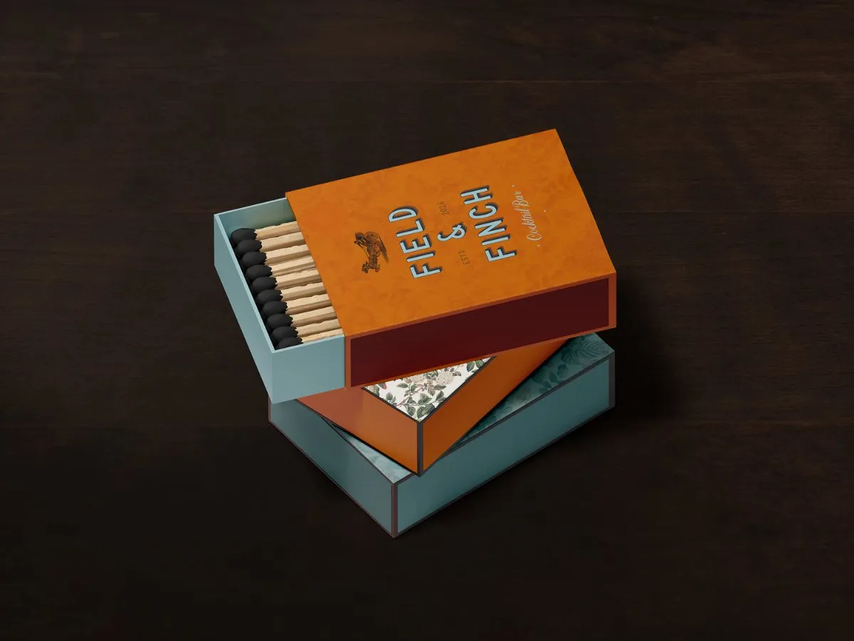 Field and Finch matchbox packaging in orange and teal